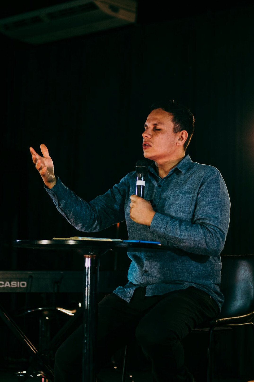 Person rehearsing a speech alone in an empty conference room