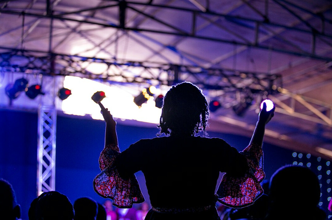 Woman public speaker with headset microphone presenting on stage